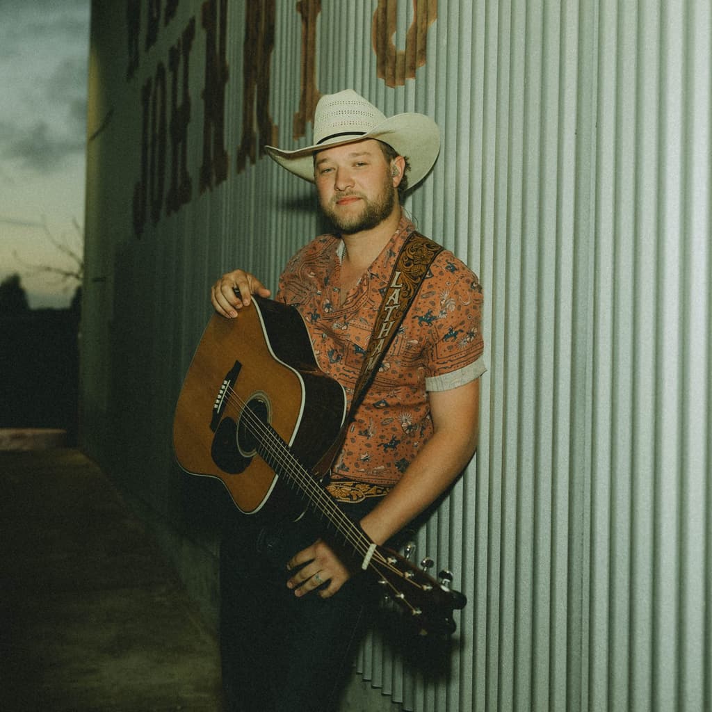 Singer Gunnar Latham with a guitar